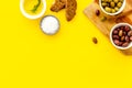 Appetizer. Olives in bowl and bread on cutting board from above space for text