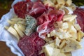 Appetizer plate: various cheeses, salami and ham on the table Royalty Free Stock Photo