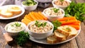 Appetizer platter with dips, vegetables, and toasted bread on wooden surface Royalty Free Stock Photo