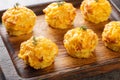 Appetizer potato muffins with bacon and cheese on wooden board closeup. Horizontal