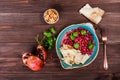 Appetizer with red bean, walnut, butter, coriander, parsley, chips on plate on wooden background. Healthy food.