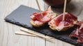 Appetizer Serrano ham with toasted bread Royalty Free Stock Photo
