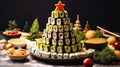 appetizer in shape of Christmas tree from rolls, sushi, red fish, traditional Japanese cuisine on festive New Year\'s table.