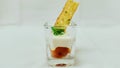 A appetizer in short glass garnished with herbs