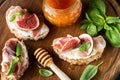 Appetizer toast with figs, ricotta cheese and prosciutto ham Royalty Free Stock Photo