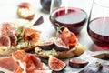 Appetizers board with traditional spanish tapas set. Italian antipasti bruschetta with prosciutto, cream cheese and figs for wine