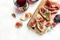 Appetizers board with traditional spanish tapas set. Italian antipasti bruschetta with prosciutto, cream cheese and figs for wine