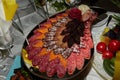 Appetizers boards with assorted meat and salami. Charcuterie platter. Table setting in a restaurant. Close-up Royalty Free Stock Photo