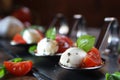 Appetizers with mozzarella and tomato on spoon - selective focus Royalty Free Stock Photo