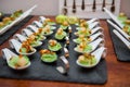 Appetizers in Porcelain spoons on black stone platter Royalty Free Stock Photo