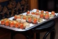 Appetizers on silver platter on wood chair Royalty Free Stock Photo