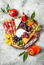 Appetizers table with antipasti snacks. Cheese and meat variety board over grey concrete background. Top view, flat lay. Royalty Free Stock Photo