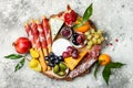 Appetizers table with antipasti snacks. Cheese and meat variety board over grey concrete background. Top view, flat lay. Royalty Free Stock Photo