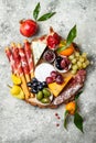 Appetizers table with antipasti snacks. Cheese and meat variety board over grey concrete background. Top view, flat lay. Royalty Free Stock Photo