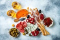 Appetizers table with antipasti snacks and wine in glasses. Authentic traditional spanish tapas set, cheese and meat platter