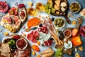 Appetizers table with antipasti snacks and wine in glasses. Bruschetta or authentic traditional spanish tapas set, cheese and meat Royalty Free Stock Photo