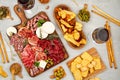 Appetizers table with differents antipasti, charcuterie, snacks and wine. Sausage, ham, tapas, olives, cheese and crackers for