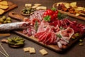 Appetizers table with differents antipasti, cheese, charcuterie, snacks and wine. Sausage, ham, tapas, olives, cheese and crackers Royalty Free Stock Photo