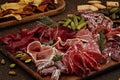 Appetizers table with differents antipasti, cheese, charcuterie, snacks and wine. Sausage, ham, tapas, olives, cheese and crackers Royalty Free Stock Photo