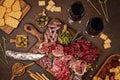 Appetizers table with differents antipasti, cheese, charcuterie, snacks and wine. Sausage, ham, tapas, olives, cheese and crackers Royalty Free Stock Photo