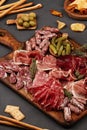 Appetizers table with differents antipasti, cheese, charcuterie, snacks and wine. Sausage, ham, tapas, olives, cheese and crackers Royalty Free Stock Photo