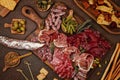 Appetizers table with differents antipasti, cheese, charcuterie, snacks and wine. Sausage, ham, tapas, olives, cheese and crackers Royalty Free Stock Photo