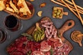 Appetizers table with differents antipasti, cheese, charcuterie, snacks and wine. Sausage, ham, tapas, olives, cheese and crackers Royalty Free Stock Photo