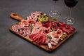 Appetizers table with differents antipasti, cheese, charcuterie, snacks and wine. Sausage, ham, tapas, olives, cheese and crackers Royalty Free Stock Photo