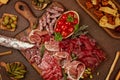 Appetizers table with differents antipasti, cheese, charcuterie, snacks and wine. Sausage, ham, tapas, olives, cheese and crackers Royalty Free Stock Photo