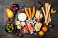 Appetizers table with italian antipasti snacks. Cheese and charcuterie variety board over rustic wooden background.