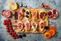 Appetizers table with italian antipasti snacks and wine in glasses. Brushetta or authentic traditional spanish tapas set