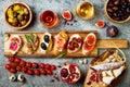 Appetizers table with italian antipasti snacks and wine in glasses. Brushetta or authentic traditional spanish tapas set