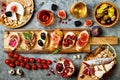 Appetizers table with italian antipasti snacks and wine in glasses. Brushetta or authentic traditional spanish tapas set Royalty Free Stock Photo