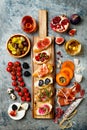 Appetizers table with italian antipasti snacks and wine in glasses. Brushetta or authentic traditional spanish tapas set