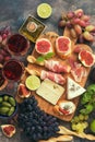 Appetizers table with italian antipasti snacks and wine in glasses . Traditional italian bread sticks grissini with prosciutto ham