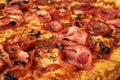 Appetizing background pepperoni pizza with bacon closeup of filling the frame