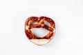 Appetizing Bavarian pretzel isolated on a white background. Top view, copy space, isolated