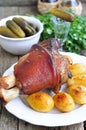 Appetizing Bavarian roast pork knuckle on cutting board