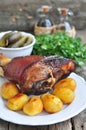 Appetizing Bavarian roast pork knuckle on cutting board