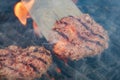 Appetizing beef hamburgers are roasting on grill grid Royalty Free Stock Photo