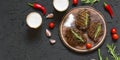 Appetizing beef steaks, beer and rosemary. top veiw Royalty Free Stock Photo