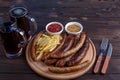 Appetizing beer snacks. Grilled sausages and french fries served Royalty Free Stock Photo