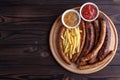 Appetizing beer snacks set. Grilled sausages and french fries se Royalty Free Stock Photo