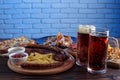 Appetizing beer snacks set. Pork slices, grilled sausages and fr Royalty Free Stock Photo