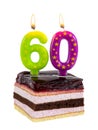 Appetizing birthday cake with burning candles for 60th anniversary