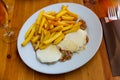 Pork steaks topped with melted mozzarella served with fries Royalty Free Stock Photo