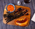 Appetizing calsot served with Romesco sauce and sausage butifarra