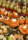 Appetizing canapes with fish on the buffet table. Business meetings and celebrations. Close-up. Vertical