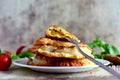 Delicious fried chebureks on a plate, small tomatoes, sprigs of Basil and hot pepper on a gray background. Fried meat pies on a pl Royalty Free Stock Photo