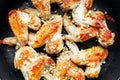 Appetizing chicken wings fried in a pan